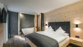 Luxury double bedroom with bathtub in the Dolomites